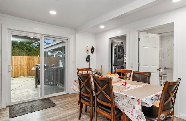 dining room with stacked washer and dryer, light wood-type flooring, and recessed lighting