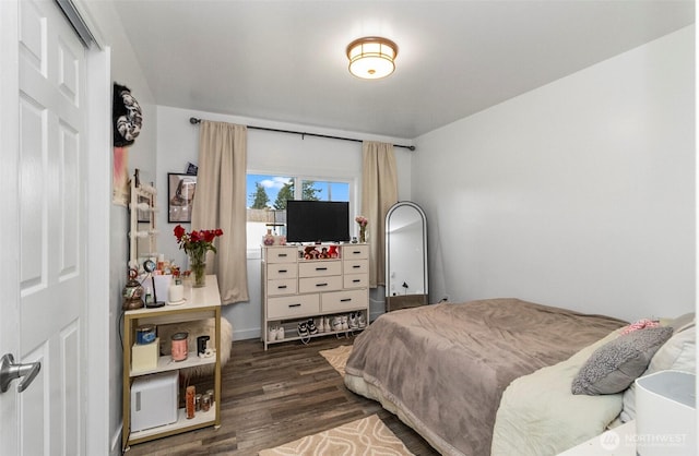 bedroom with dark wood-style floors