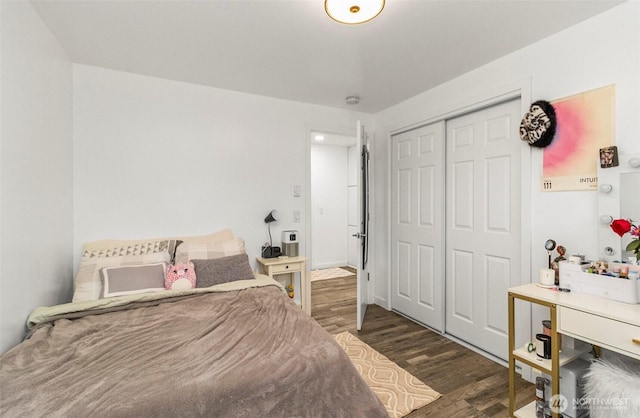 bedroom featuring a closet and dark wood finished floors