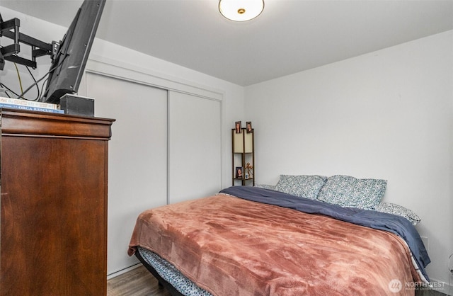 bedroom with a closet and wood finished floors