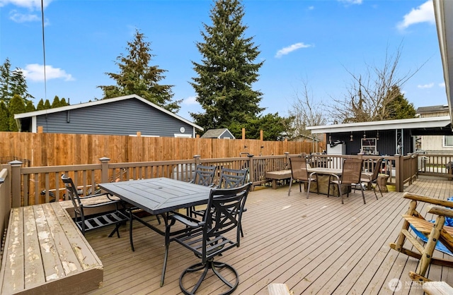 wooden deck featuring outdoor dining space and a fenced backyard