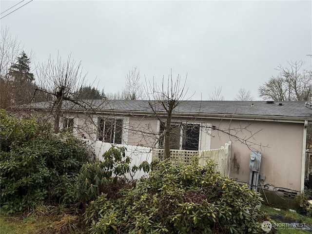 view of home's exterior with roof with shingles