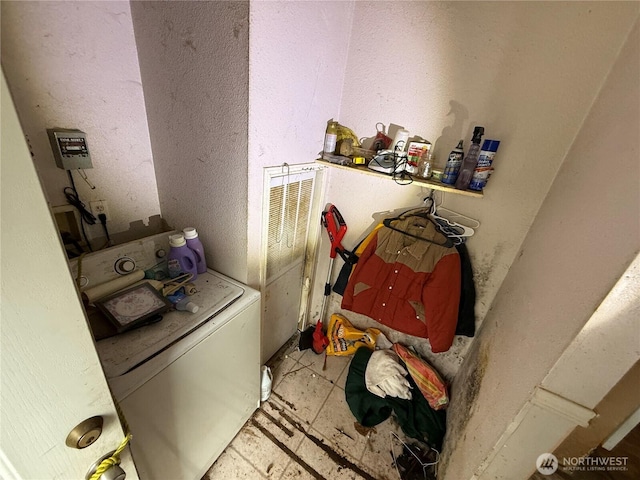 washroom with laundry area and washer / dryer