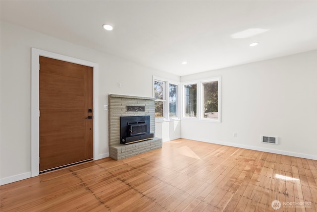 unfurnished living room featuring recessed lighting, visible vents, baseboards, and wood finished floors