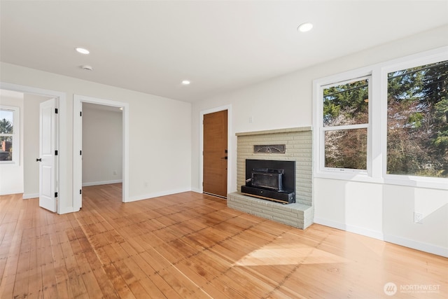 unfurnished living room featuring light wood finished floors, plenty of natural light, and recessed lighting