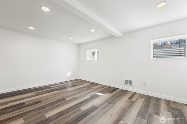 empty room with baseboards, beamed ceiling, visible vents, and recessed lighting