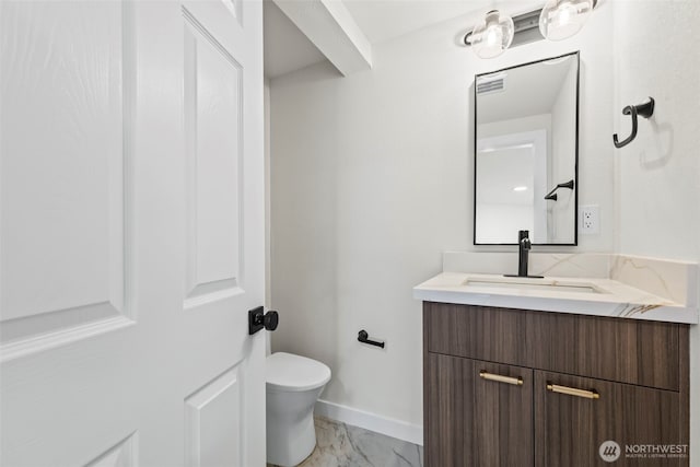 half bath featuring marble finish floor, vanity, toilet, and baseboards