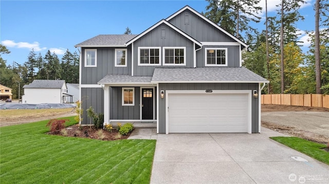 view of front of home featuring a garage, driveway, roof with shingles, fence, and a front lawn