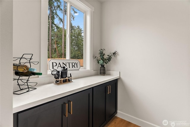 bar featuring baseboards and light wood-style floors