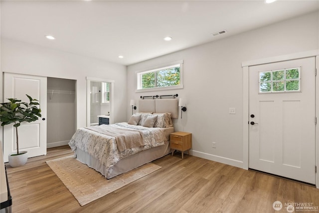 bedroom with recessed lighting, visible vents, light wood-style floors, connected bathroom, and baseboards