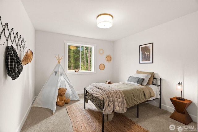 bedroom with light carpet and baseboards