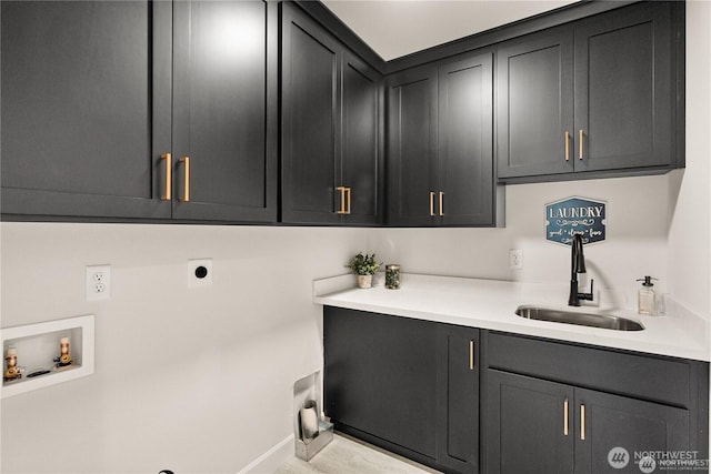 laundry room featuring hookup for an electric dryer, washer hookup, a sink, baseboards, and cabinet space