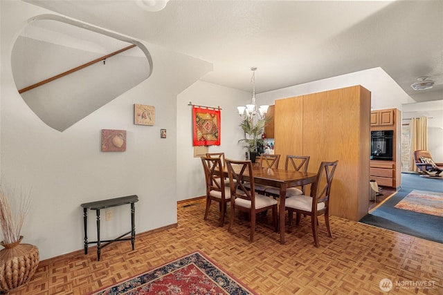 dining room with a notable chandelier