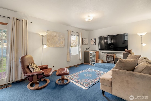 carpeted living room featuring baseboards and visible vents