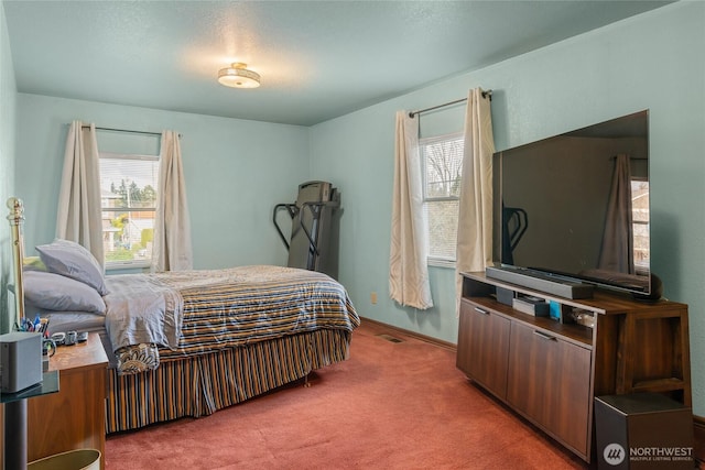 bedroom featuring baseboards, visible vents, and light colored carpet