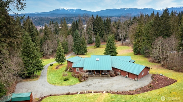 drone / aerial view with a mountain view and a view of trees