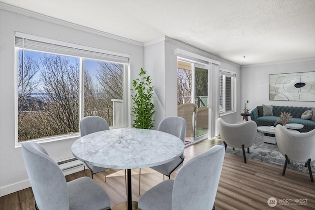 dining space with crown molding, a wealth of natural light, and dark wood finished floors