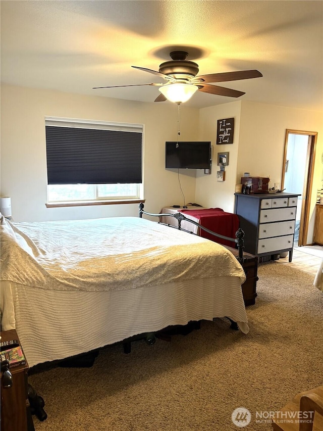 bedroom featuring ceiling fan and carpet