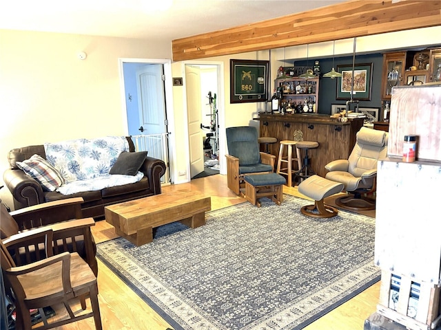 living area featuring light wood finished floors and a dry bar