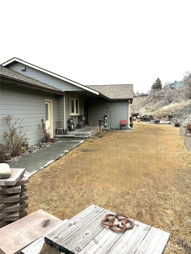 back of property with a patio and a yard