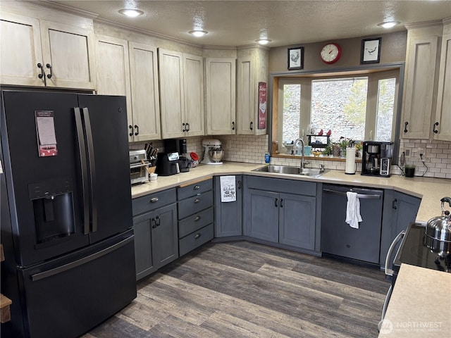 kitchen featuring black appliances, gray cabinets, a sink, and light countertops