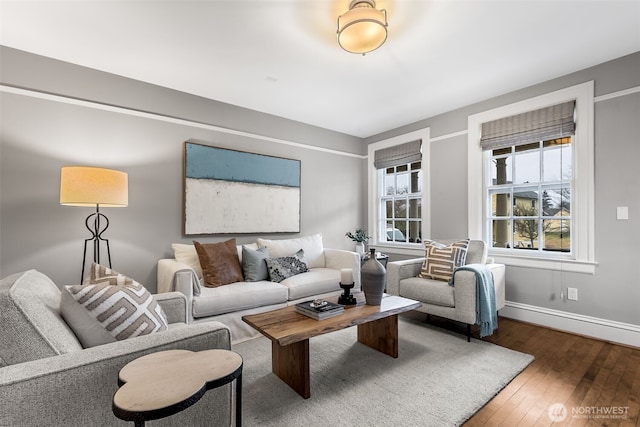 living area featuring baseboards and wood finished floors