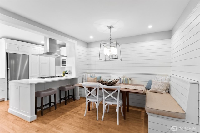 dining room with light wood finished floors, breakfast area, an inviting chandelier, and recessed lighting