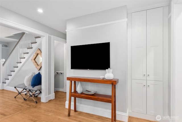 interior space featuring light wood-type flooring, stairway, baseboards, and recessed lighting