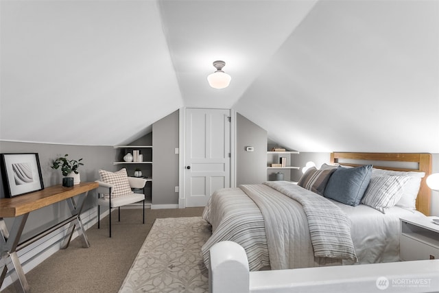 bedroom with carpet, baseboards, and vaulted ceiling