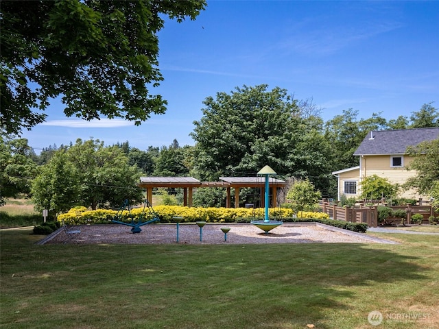 view of play area with a vegetable garden, a lawn, and a gazebo