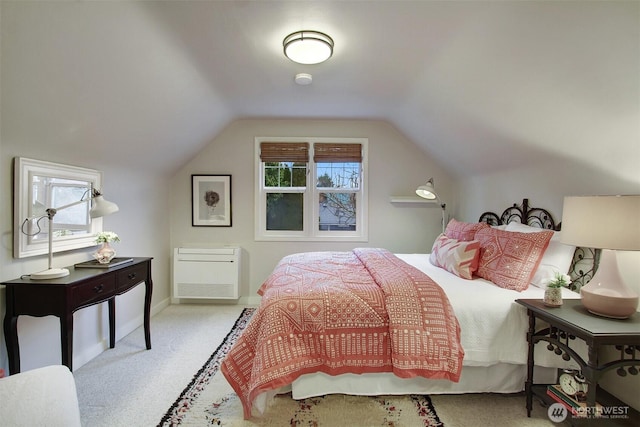 bedroom featuring multiple windows, vaulted ceiling, and light colored carpet