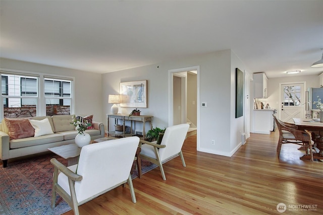 living area featuring light wood-type flooring and baseboards