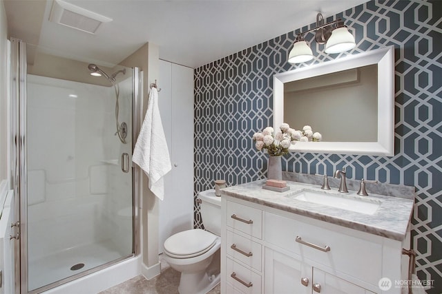 bathroom featuring wallpapered walls, a stall shower, and vanity