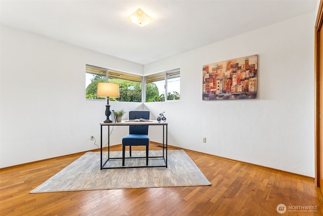 office featuring baseboards and wood-type flooring