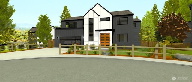 view of front of property featuring a garage, a fenced front yard, board and batten siding, and concrete driveway