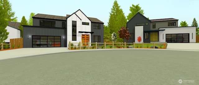 view of front of home featuring driveway, board and batten siding, an attached garage, and fence