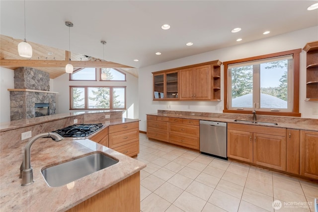 kitchen featuring stainless steel appliances, open shelves, a sink, and light stone counters