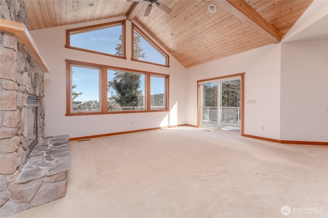 unfurnished living room with wood ceiling, carpet, a stone fireplace, high vaulted ceiling, and beam ceiling