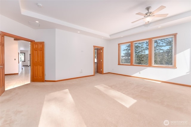 unfurnished room with light carpet, baseboards, a ceiling fan, a tray ceiling, and recessed lighting