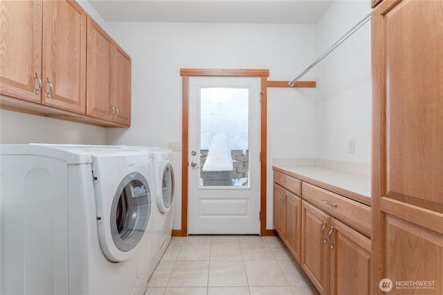 laundry area with cabinet space, light tile patterned floors, and independent washer and dryer