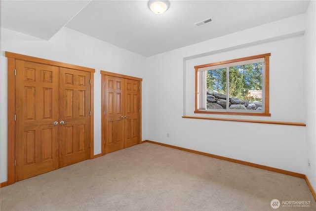6760 Forest Ridge Dr, Wenatchee, WA 98801 - unfurnished bedroom featuring carpet floors and two closets