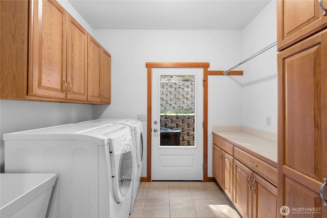 6760 Forest Ridge Dr, Wenatchee, WA 98801 - laundry area featuring cabinet space, washing machine and dryer, and light tile patterned floors