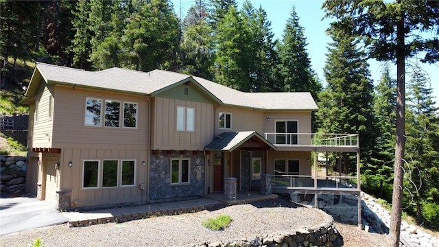6760 Forest Ridge Dr, Wenatchee, WA 98801 - view of front facade with board and batten siding, stone siding, and a balcony