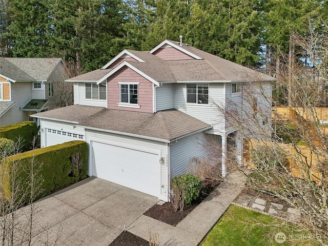 view of front of property featuring driveway, an attached garage, and roof with shingles