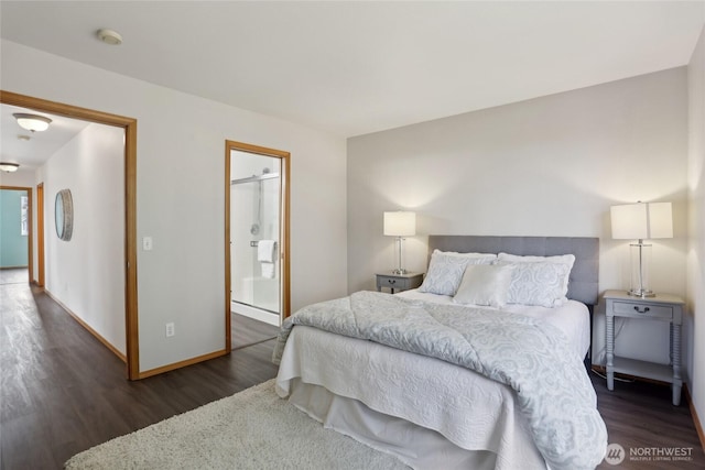 bedroom with ensuite bath, baseboards, and wood finished floors