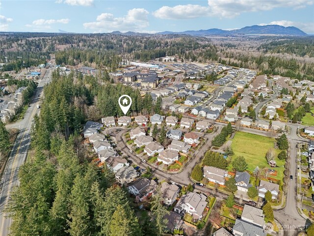 bird's eye view featuring a forest view, a residential view, and a mountain view