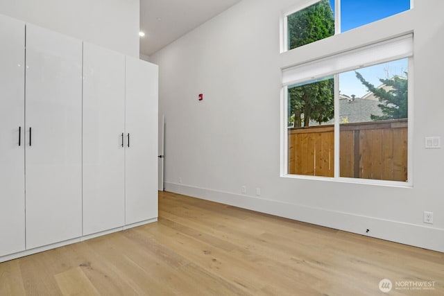 unfurnished bedroom with baseboards, recessed lighting, and light wood-style floors