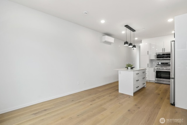 kitchen with stainless steel appliances, light countertops, hanging light fixtures, white cabinets, and a kitchen island