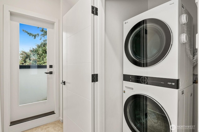 laundry area featuring stacked washer / drying machine