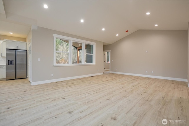 unfurnished living room featuring recessed lighting, vaulted ceiling, light wood finished floors, and baseboards